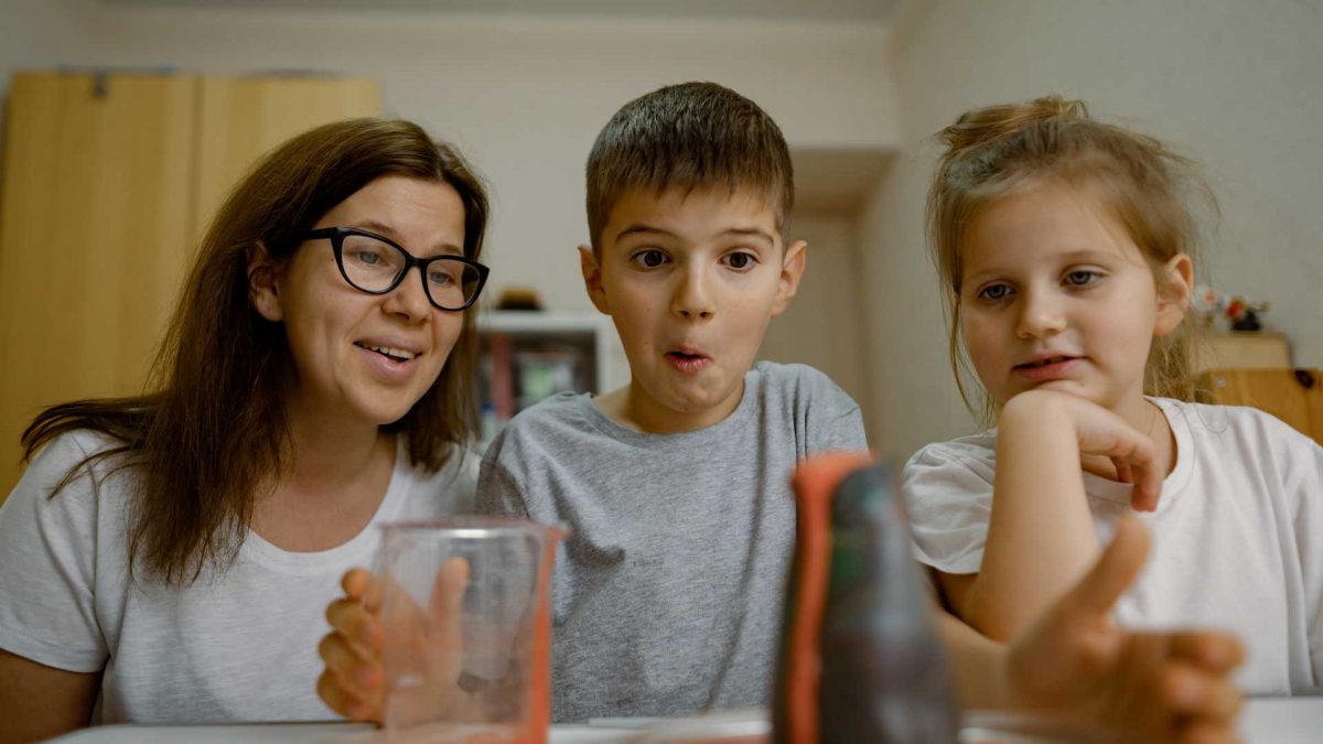 mum and children at home conducting volcano science experiment